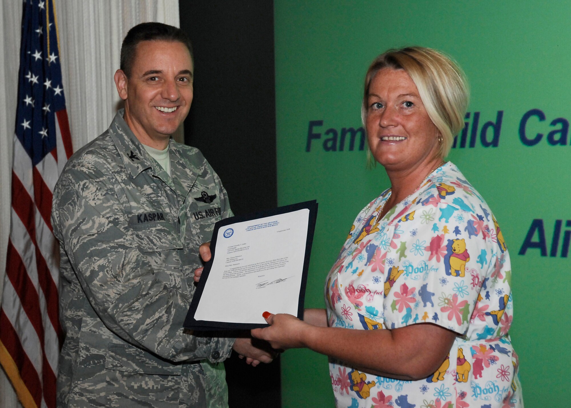 CANNON AIR FORCE BASE, N.M. -- Alison Patterson receives the Air Force 2007 Family Child Care Provider of the Year Award from Col. Hans Kaspar, 27th Special Operations Wing vice commander.  Mrs. Patterson received the award Sep. 17 at the weekly wing staff meeting.  (U.S. Air Force photo/Senior Airman Liliana Moreno)  