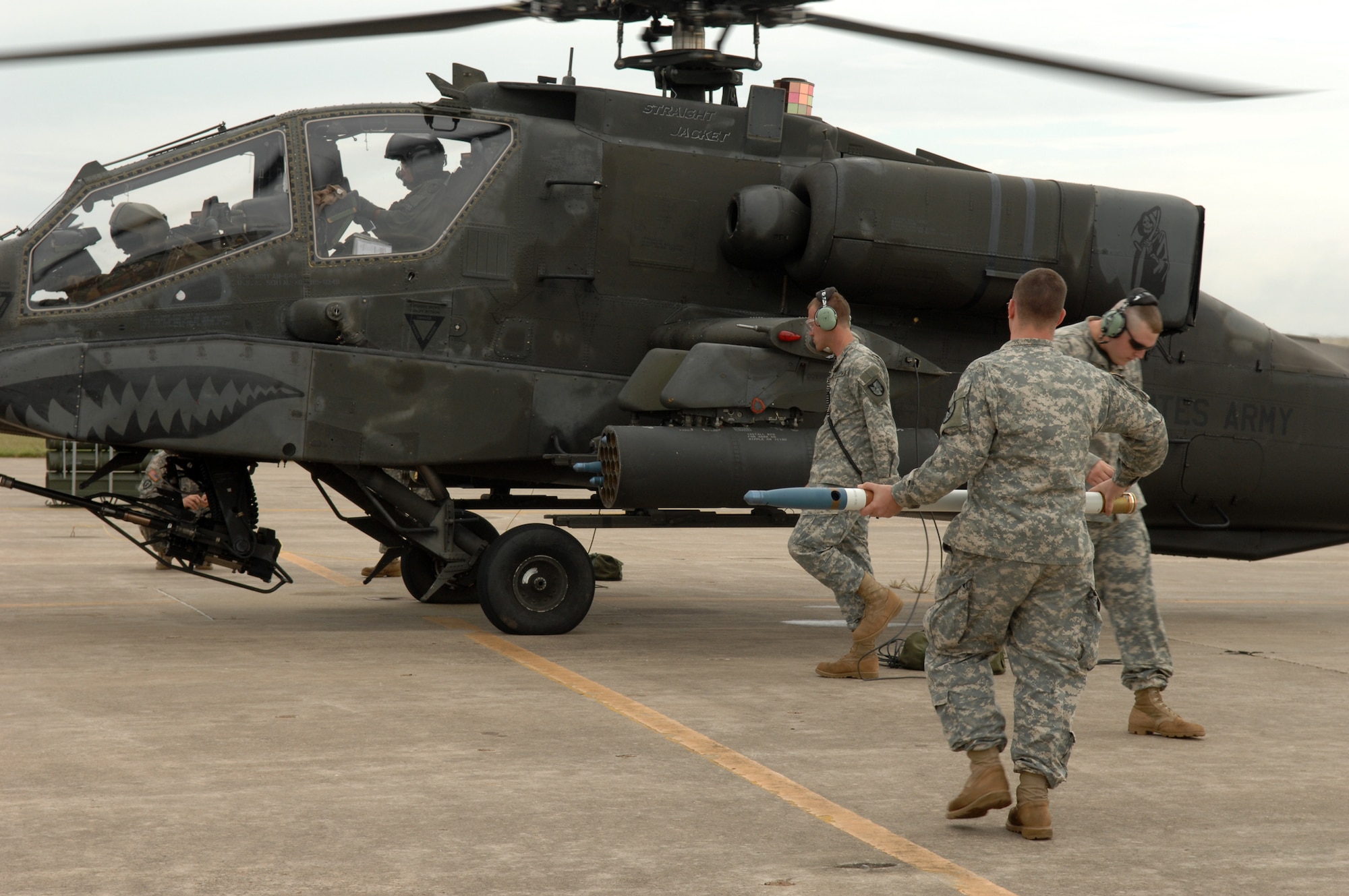 WHITEMAN AIR FORCE BASE, Mo. – Army Sgts.Chistopher Lorey, Brian Pummill and David Ezell, all from the 1-135th Attack Recon Battalion, load 2.76 inch rockets on an AH-64A Apache Sept. 6. The Missouri Army National Guard’s 1-135th Attack Recon Battalion recently implemented a new training program that allows pilots to arm and fly three AH-64 Apache helicopters from Whiteman AFB to Fort Leonard Wood for the first time to practice aerial gunnery at their monthly drill. (U.S. Air Force photo/Senior Airman Stephen Linch)