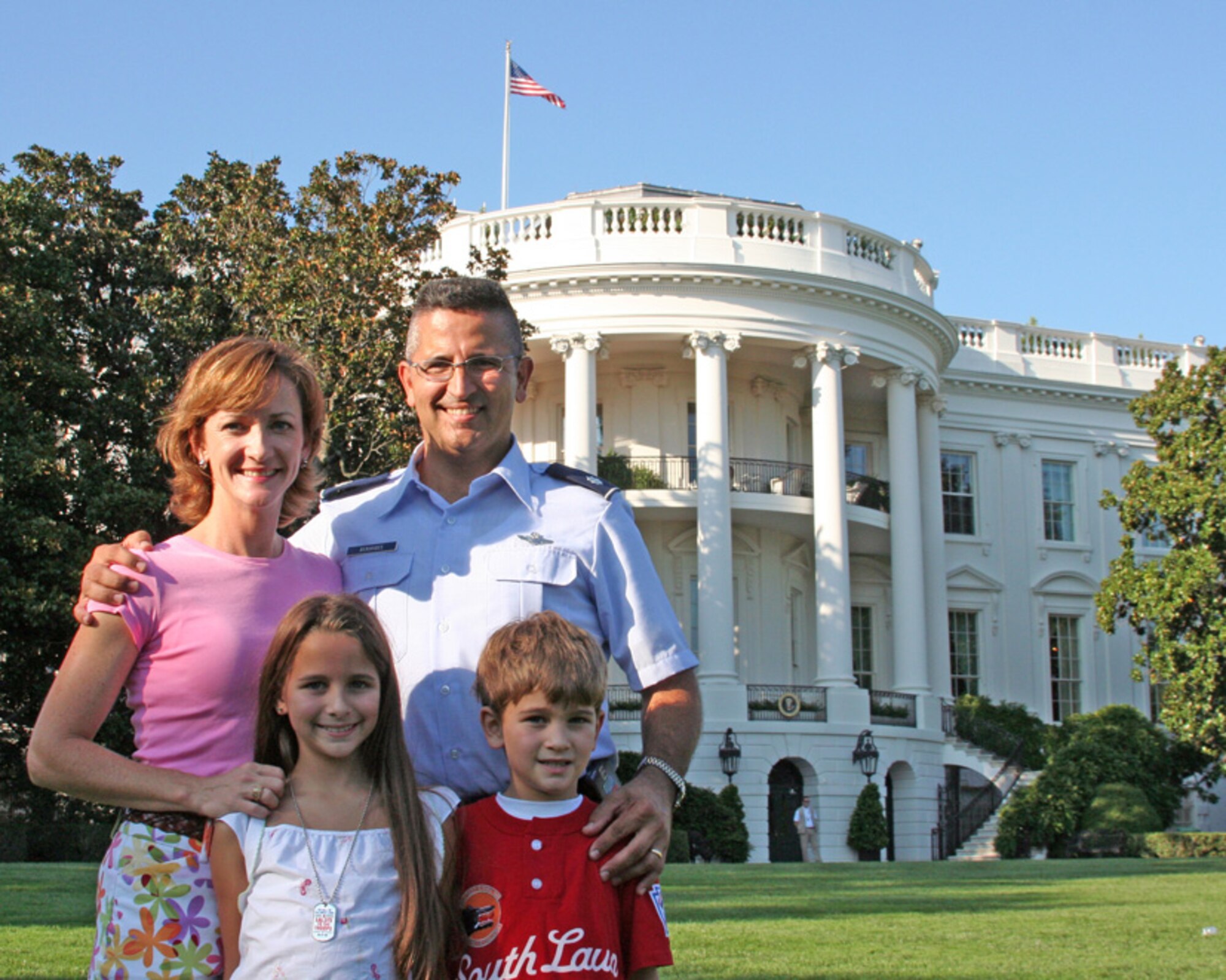 Lt. Col. Beruvides, 49th Test and Evaluation Squadron, stands with his wife Jennifer, daughter Adriana and son Steven in front the White House in Washington Sept. 7.  The family was there for the annual "Tee Ball on the South Lawn" event held by President George Bush. Children from military families are invited to play a game of tee ball at the White House every year.  Steven, a member of the Stripes team, hit a home run during the game.  U.S. Air Force photo.