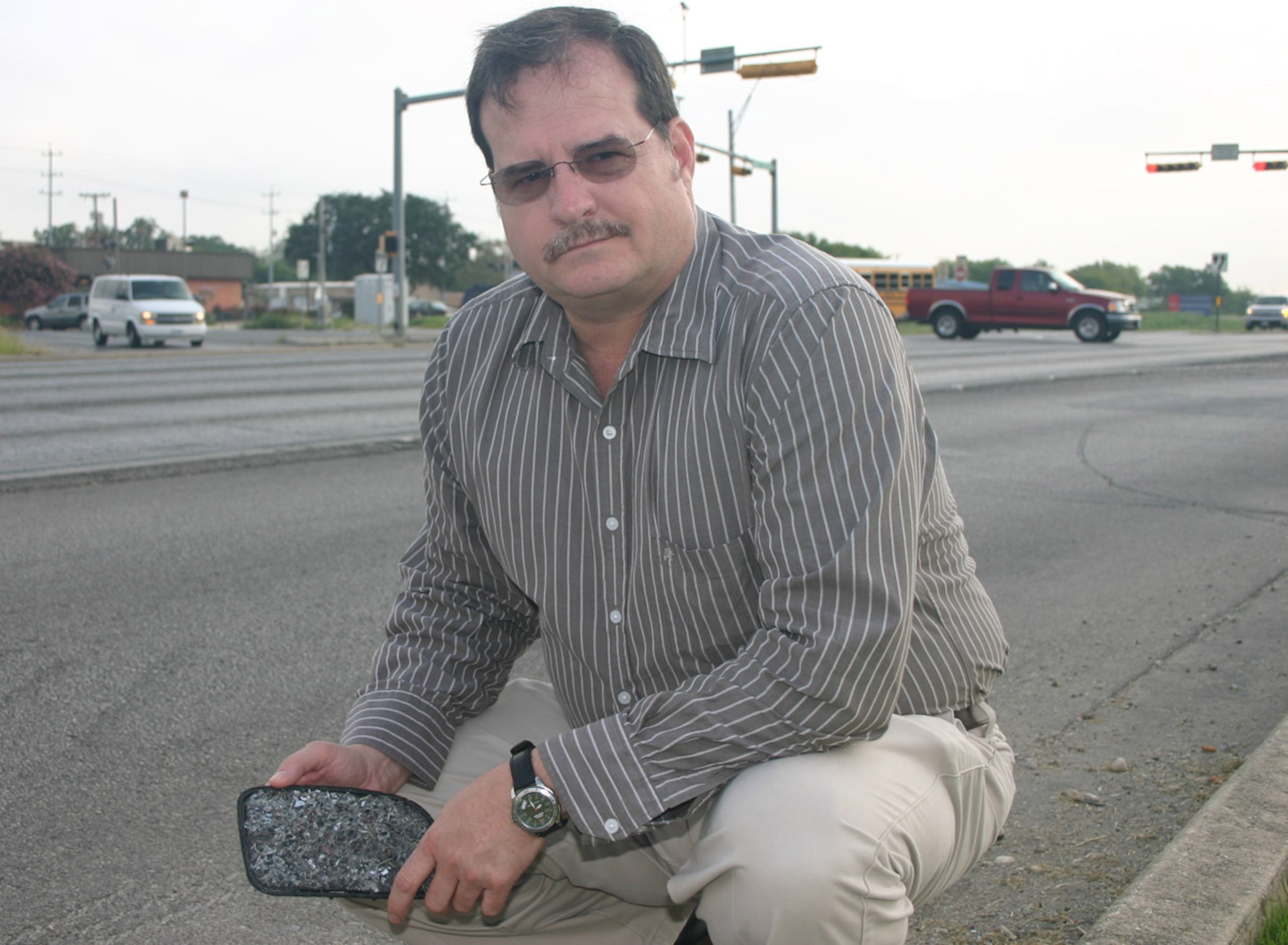 Greg Robert, Air Force Manpower Agency systems administrator, revisits the intersection outside the Randolph Air Force Base, Texas main gate where he witnessed a car accident and saved the life of a critically injured man in April. For his efforts Mr. Roberts received the Air Force Command Valor Award on Aug. 29. (U.S. Air Force photo by Master Sgt. James Brabenec)