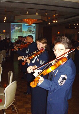 MCGUIRE AIR FORCE BASE, N.J. -- Violinists with the  Air Force Strolling Strnigs provide entertainment during the 514th Air Mobility Wing's Military Ball held Sept. 6 at the Grand Varsailles Ballroom located in Mount Laurel, N.J. Close to 450 military members, retirees and guests celebrate the 60th Anniversary of the Air Force Reserve. (U.S. Air Force photo/Master Sgt. Derek Williams)
