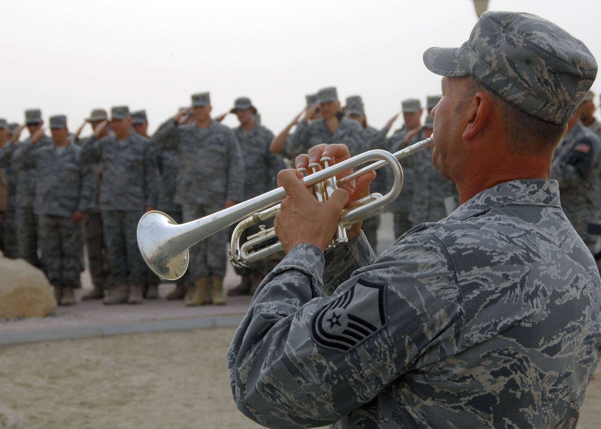 SOUTHWEST ASIA -- Master Sgt. Thomas Jennings, 386th Expeditionary Civil Engineer Squadron, plays taps during the 9/11 remembrance ceremony on Sept. 11 at an air base in Southwest Asia. The ceremony included a wreath laying ceremony, a twenty-one-gun salute and the playing of taps to honor the memory of those that perished and survived the terrorist attacks of Sept. 11. (U.S. Air Force photo/Tech. Sgt. Raheem Moore).