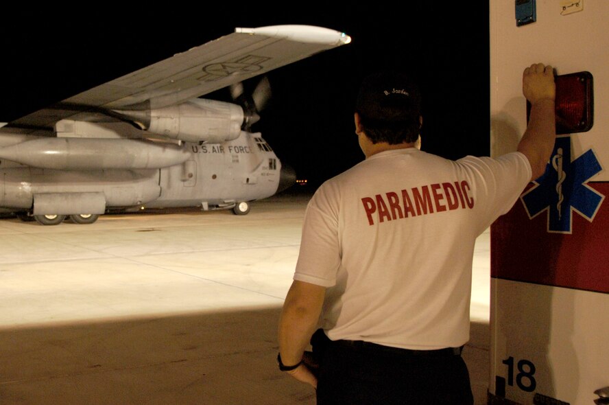 A paramedic watches as a C-130 Hercules from Little Rock Air Force Base, Ark., comes to a stop on the tarmac in Corpus Christi, Texas, Sept. 11. The C-130 arrived at Corpus Christie to transport patients to a safe location out of Hurricane Ike's path. (U.S. Air Force Photo by Staff Sgt. Joseph Swafford Jr.)