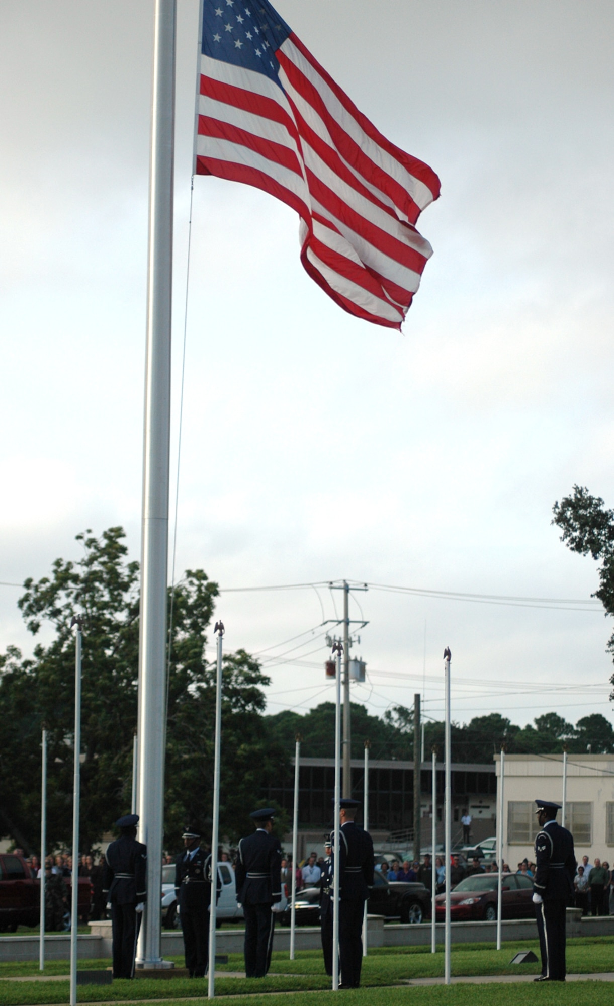 EGLIN AIR FORCE BASE, Fla. -- In honor of the 7th anniversary of Sept. 11, 2001, an honor guard reveille detail lowers the flag in front of the Air Armament Center to half staff. The ceremony was accompanied by a prayer and the playing of Taps. (US Air Force photo/ Airman 1st Class Anthony Jennings)