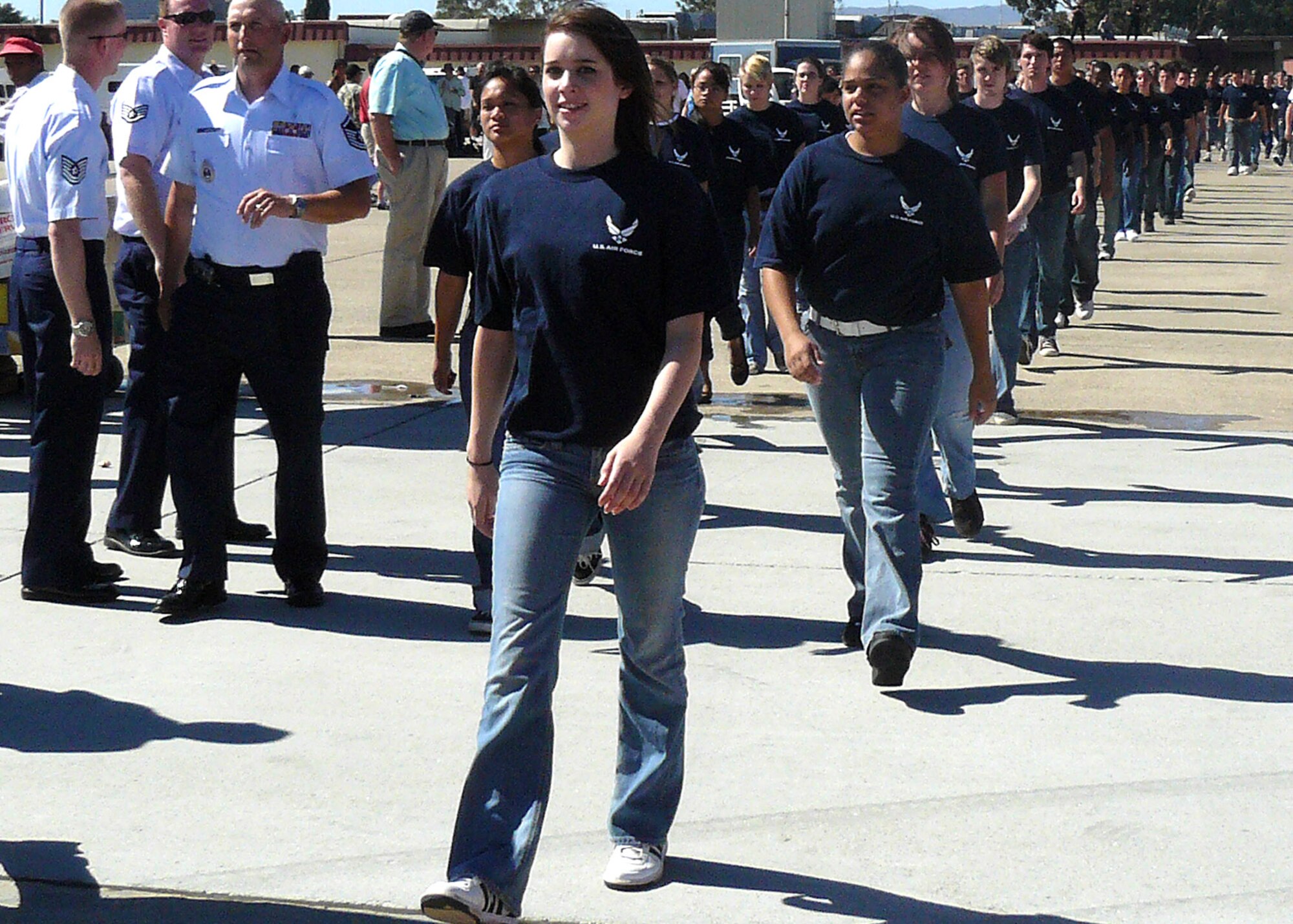 Members of the 364th Recruiting Squadron Delayed Entry Program march out on the Travis Air Force Base, Calif., flightline Aug. 30 during Travis Air Expo 2008 to participate in the largest DEP swearing-in ceremony to date. Lt. Col. Greg Thomas, commander of the Air Force Thunderbirds, administered the oath of enlistment to 154 future Airmen before a crowd of more than 80,000 airshow spectators. (U.S. Air Force photo/Staff Sgt. Justin Gress) 