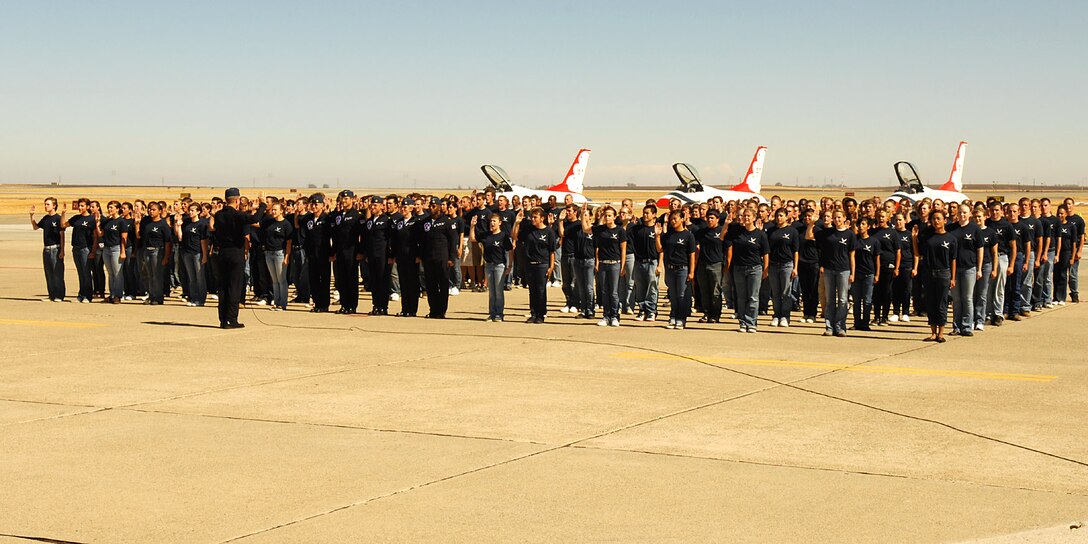 Lt. Col. Greg Thomas, commander of the Air Force Thunderbirds, administers the oath of enlistment Aug. 30 to 154 future Airmen at Travis Air Force Base, Calif.  The group, members of the 364th Recruiting Squadron Delayed Entry Program, were sworn in at the Travis Air Expo 2008 before a crowd of more than 80,000 airshow spectators. The event is the largest DEP swear-in ceremony to date. (U.S. Air Force photo)