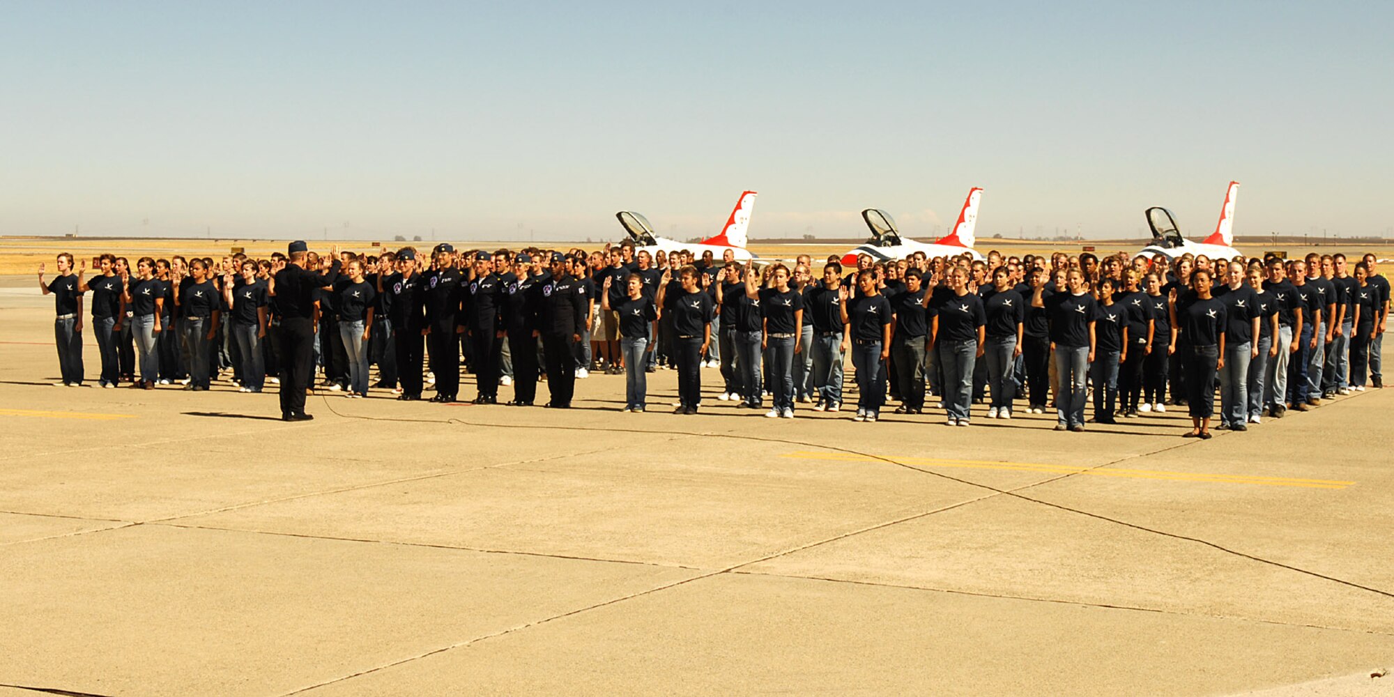 Lt. Col. Greg Thomas, commander of the Air Force Thunderbirds, administers the oath of enlistment Aug. 30 to 154 future Airmen at Travis Air Force Base, Calif.  The group, members of the 364th Recruiting Squadron Delayed Entry Program, were sworn in at the Travis Air Expo 2008 before a crowd of more than 80,000 airshow spectators. The event is the largest DEP swear-in ceremony to date. (U.S. Air Force photo)