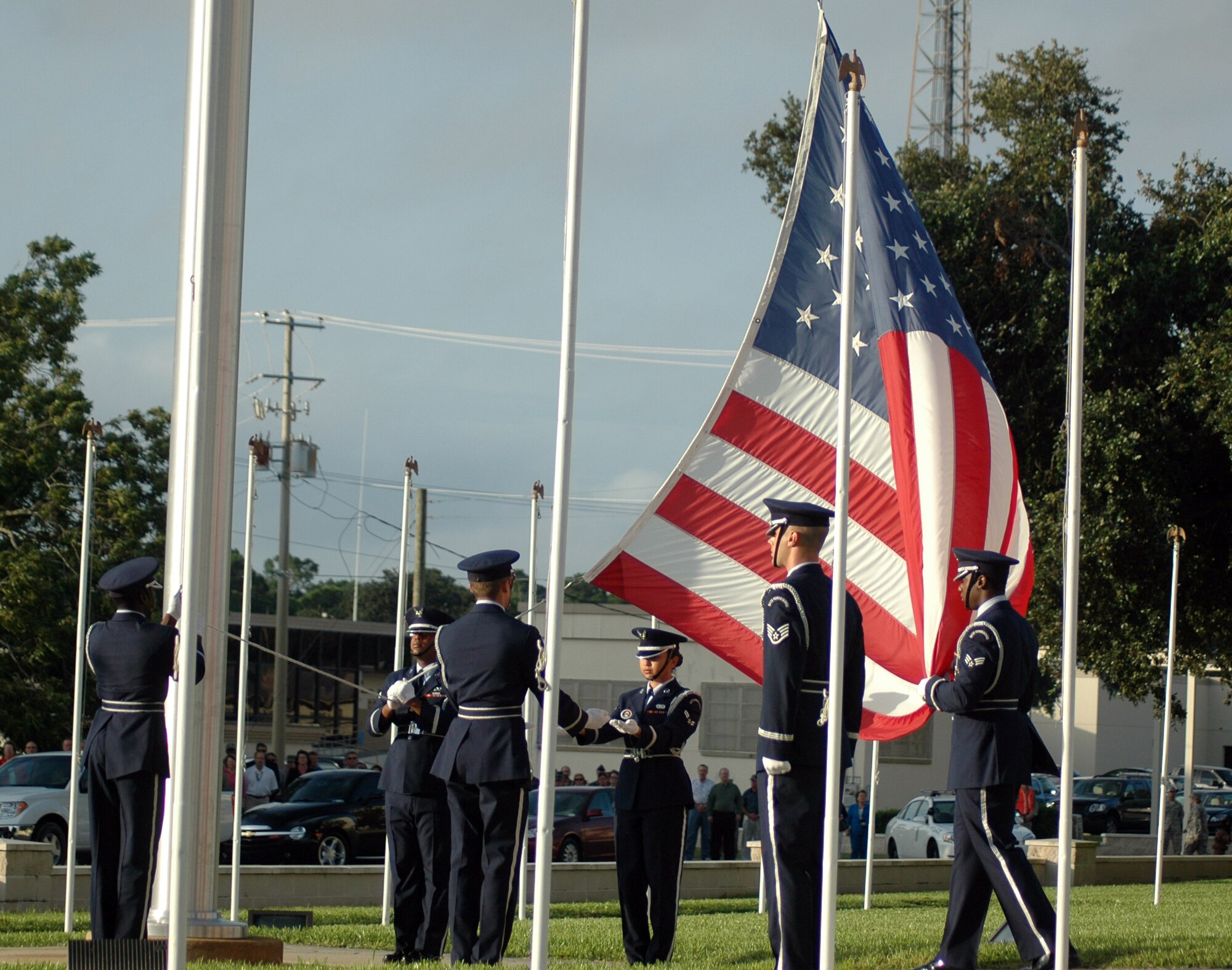EGLIN AIR FORCE BASE, Fla. -- In honor of the 7th anniversary of Sept. 11, 2001, an honor guard reveille detail lowers the flag in front of the Air Armament Center to half staff. The ceremony was accompanied by a prayer and the playing of taps. (US Air Force photo/ Airman 1st Class Anthony Jennings)