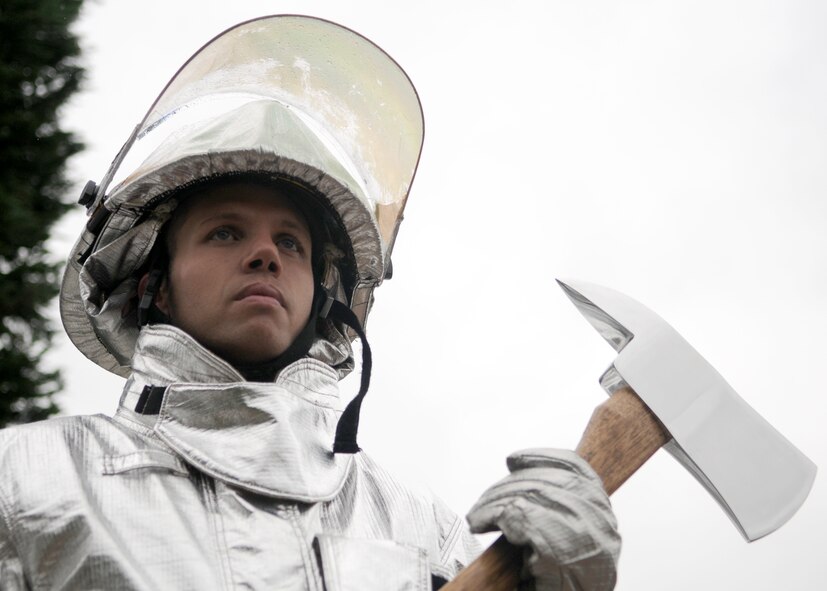Senior Airman Jayton Washington, a 100th Civil Engineer Squadron Fire Department firefighter, participates in the Sept. 11 Memorial Service held at the Bob Hope Community Center located on RAF Mildenhall, on Sept. 11, 2008. Airman Washington represented all the fallen firefighters who lost their lives on that fateful day. (U.S. Air Force photo by Staff Sergeant Jerry Fleshman)