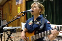 MINOT AIR FORCE BASE, N.D. -- Master Sgt. Lori Weber, a member of Night Wing, a popular and country music ensemble with the U.S. Air Force Heartland of America Band out of Offutt AFB, Neb., performs Sept. 4 for the locals of Ryder, N.D. The 91st Missile Wing sponsored the concert to show its appreciation to Ryder for the residents' support of the wing's ICBM mission. Approximately 150 people attended the event, which included a "burger burn" courtesy of the 741st Missile Squadron. (U.S. Air Force photo by Senior Airman Kelly Timney)