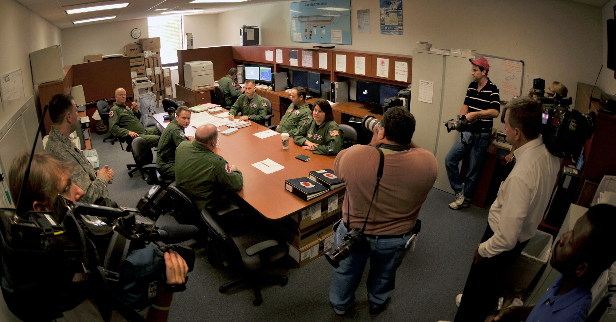 News media representatives report on an aircrew as they prepare for a mission into Hurricane Ike Sept. 10 at Keesler Air Force Base, Miss. The crew of reservists left with reporters from the Associated Press, WKRG and WVTM onboard at 10:30 a.m. to locate the center of Ike and to gather data used by forecasters at the National Hurricane Center to better predict the path and intensity of storms. (U.S. Air Force photo/Tech. Sgt. James B. Pritchett) 
