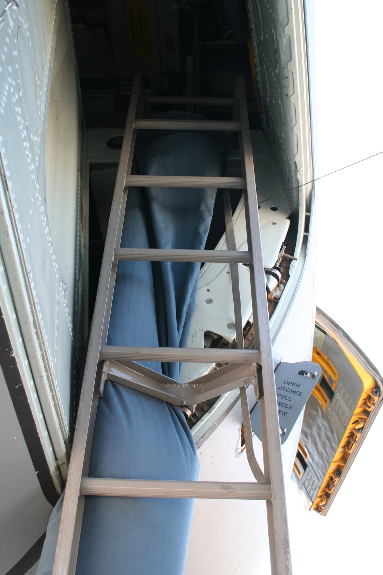 This photo shows a fabricated cooling sock as it is attached behind the crew entry ladder to the flight deck of a KC-135R Stratotanker at Sky Harbor Airport in Phoenix, Ariz., in June 2008, where the demonstration for the Air Mobility Battlelab's  KC-135 Hot Weather Cooling Sock initiative took place.  The use of the cooling sock has been recommended for fielding to Air Mobility Command by the AMB, which is located at the U.S. Air Force Expeditionary Center on Fort Dix, N.J.  (U.S. Air Force Photo)