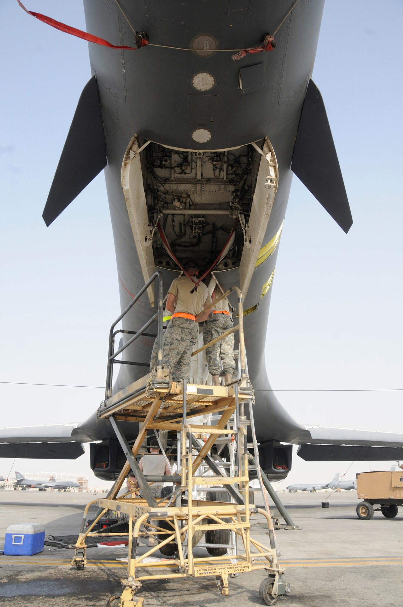 Staff Sgt. Cody Danker, crew chief for the 76th Expeditionary Depot Maintenance Squadron, and Staff Sgt. Bradley Klepac, hydraulic craftsman for the 76th Expeditionary Depot Maintenance Squadron, replace the nose landing gear of a B-1B Lancer Sept. 10, 2008, at an undisclosed air base in Southwest Asia. The expeditionary depot team deployed here to replace the entire nose landing gear.  The B-1B is often called upon to deliver precision bombs in support of Operations Iraqi and Enduring Freedom. Sergeant Danker is a native of Norman, Okla., and Sergeant Klepac hails from Bandera, Texas.  Both are deployed from Tinker Air Force Base, Okla. (U.S. Air Force photo by Staff Sgt. Darnell T. Cannady/Released)