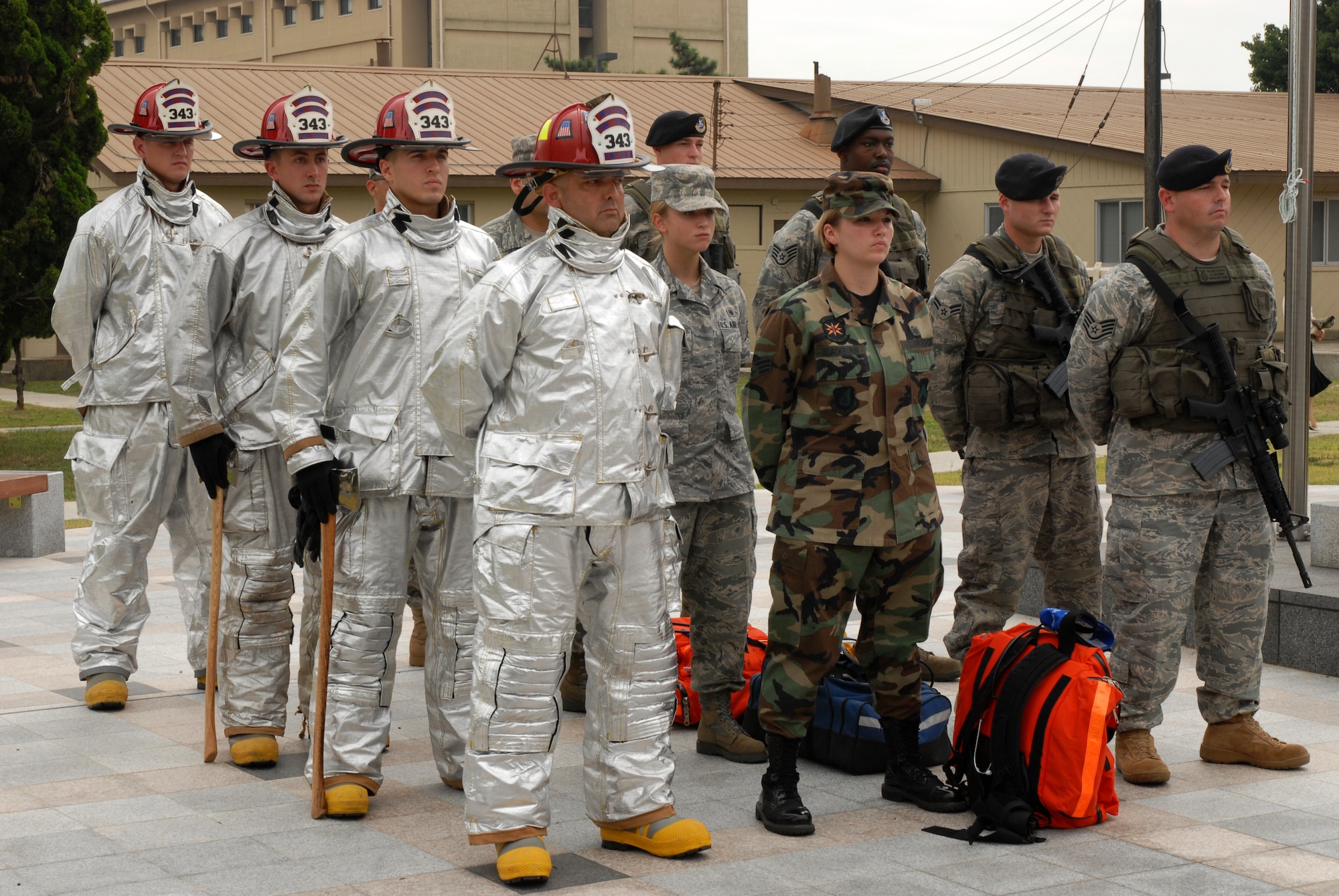 KUNSAN AIR BASE, Republic of Korea -- A formation lines up during a 9/11 ceremony at Kunsan Air Base,  Sept. 11 at the base?s Medal of Honor monument. The formation was made up of firemen, nurses, and security forces personnel to honor the fallen in the attacks Sept. 11, 2001. (U.S. Air Force photo/Senior Airman Gustavo Gonzalez)