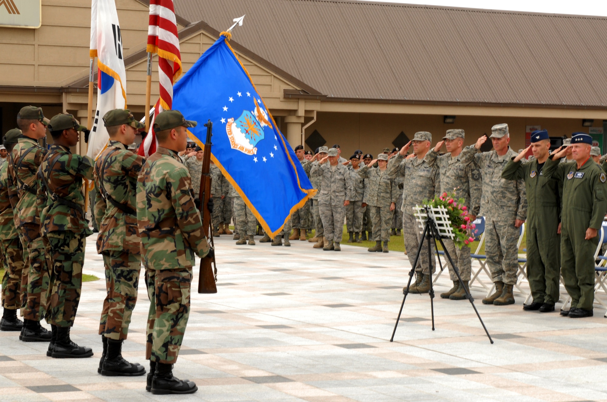 KUNSAN AIR BASE, Republic of Korea -- Members of Kunsan Air Base salute the U.S. flag during a 9/11 ceremony here, Sep 11 at the base?s Medal of Honor monument.  The remembrance ceremony has been held each year here to honor the fallen in the attacks Sept. 11, 2001. (U.S. Air Force photo/Senior Airman Gustavo Gonzalez)