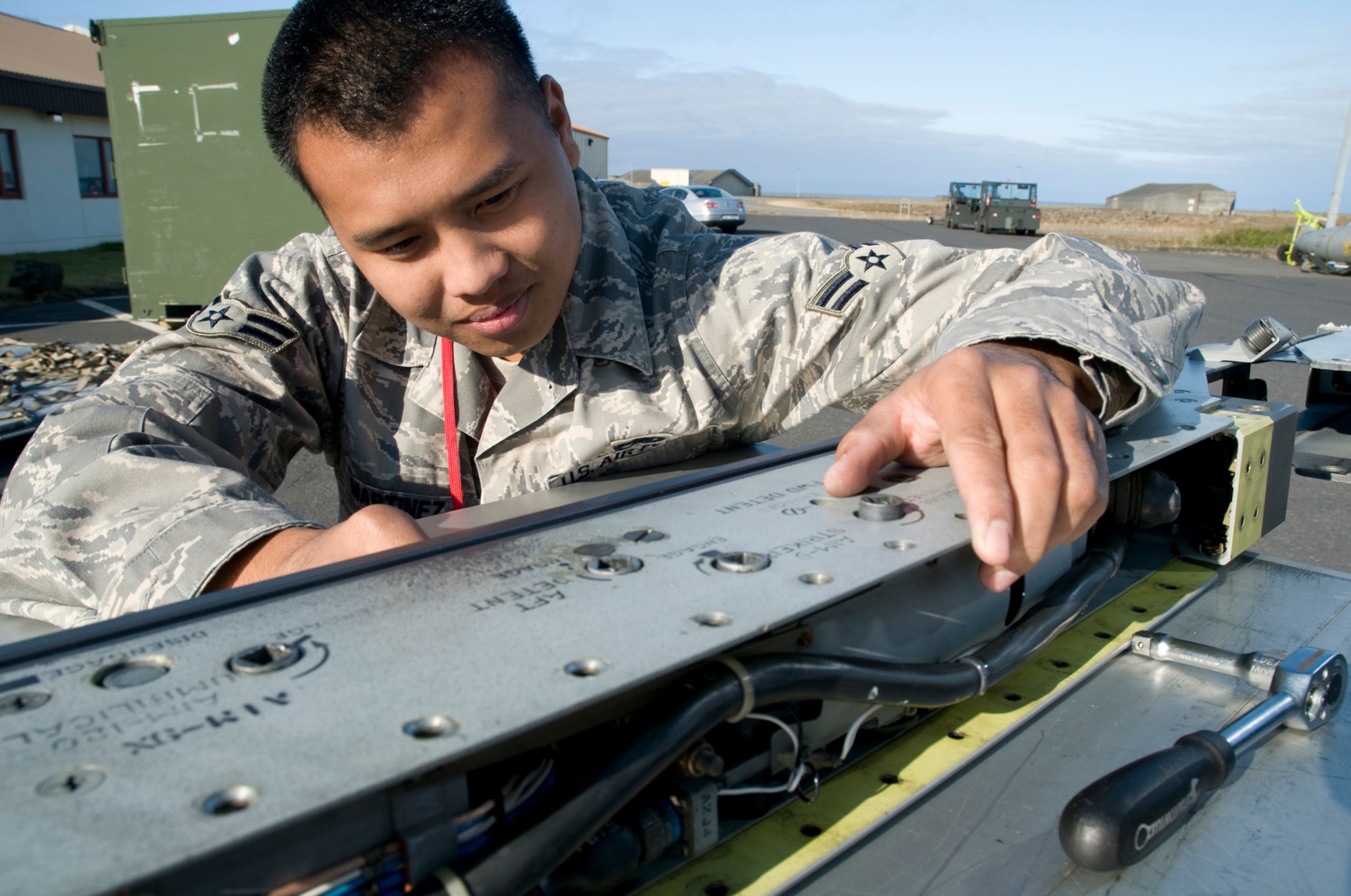 KEFLAVIK AIRPORT, Iceland ? Airman 1st Class Gomes Martinez, an armament team member from the 48th Munitions Squadron, RAF Lakenheath, United Kingdom, inspects the AIM-120 umbilical cord connector on the LAU-128 Guided Missile Launcher aboard an F-15 aircraft. He is participating in Northern Viking 2008. One of the main goals of the multinational exercise was to achieve higher levels of interoperability in air defense and maritime capabilities between participating nations. (U.S. Air Force photo by Staff Sgt. Nathan Gallahan.)