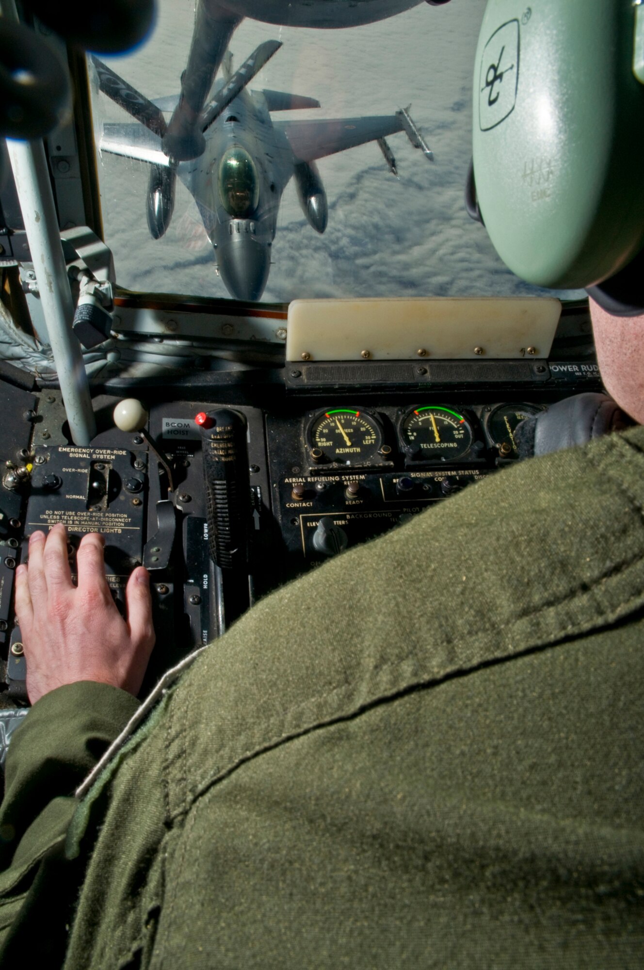 KEFLAVIK AIRPORT, Iceland ? Airman 1st Class Danny Ingram, a KC-135 boom operator, works to connect the refueler?s boom to a Norwegian F-16 so it can begin receiving fuel in the skies above Iceland Sept. 3. The two aircraft are participating in Northern Viking 2008. One of the main goals of the exercise is to achieve higher levels of interoperability in air and maritime capabilities between participating nations. Airman 1st Class Ingram said that he loves his job because of the great view.  The native of Wayne, Ill., is assigned to the 351st Air Refueling Squadron at RAF Mildenhall, United Kingdom. (U.S. Air Force photo by Staff Sgt. Nathan Gallahan.)