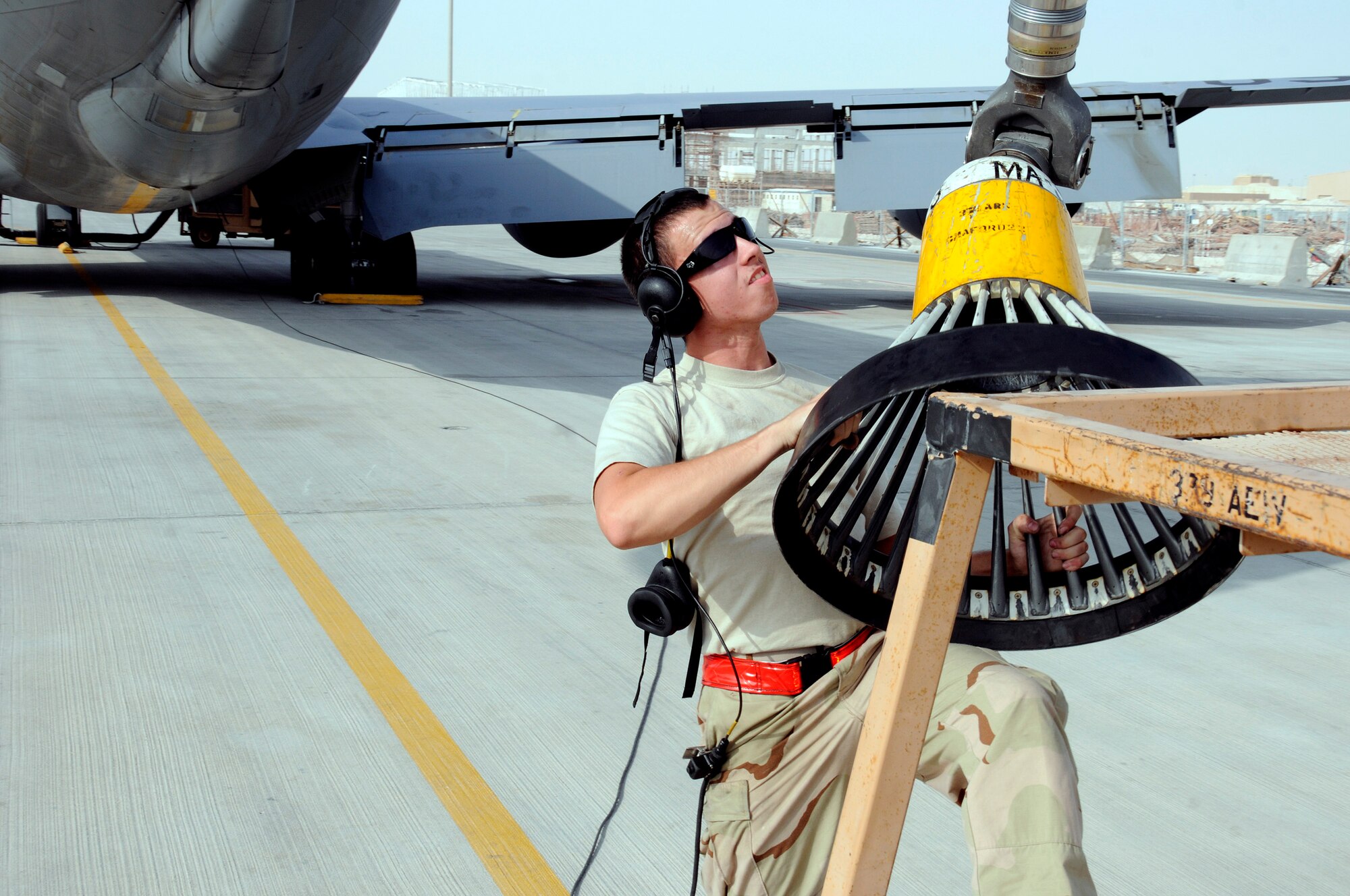 Airman 1st Class Jason Somrak, 379th Expeditionary Aircraft Maintenance Squadron, 340th Aircraft Maintenance Unit, muscles the KC-135 refueling pod off of the stand Sept.9, 2008.  The moving of the pod from the stand is one of the early steps on the pre-flight checklist here at this undisclosed air base in Southwest Asia.  The KC-135 provides aerial refueling support to Air Force, Navy, Marine Corps and allied nation aircraft engaged in Operations Iraqi and Enduring Freedom and Joint Task Force-Horn of Africa. Airman Somrak, a native of Colfax, La., is deployed from McConnell AFB, Kan. (U.S. Air Force photo by Tech. Sgt. Michael Boquette/Released)