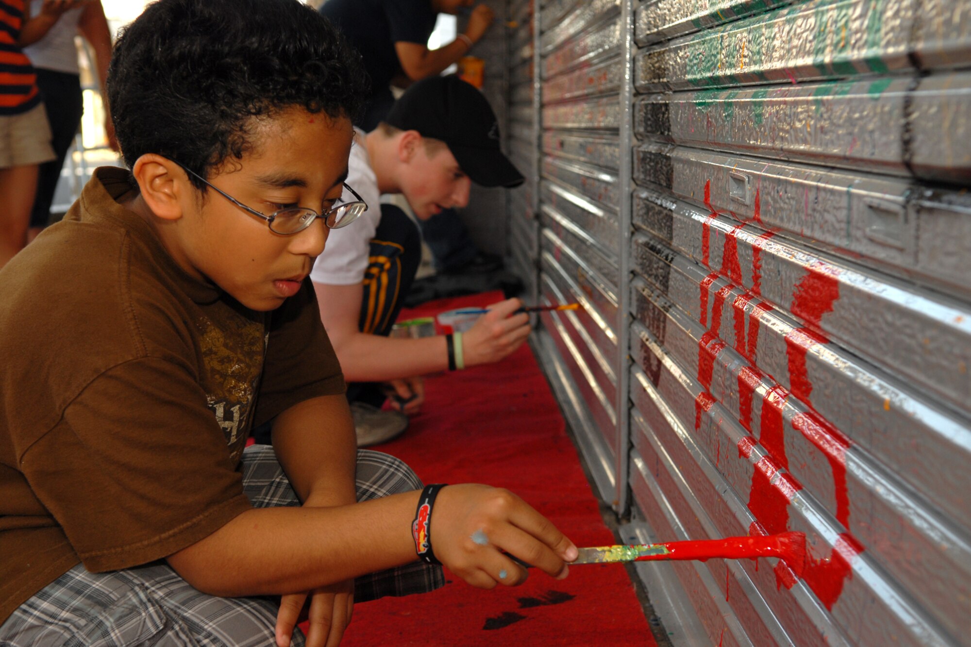 MISAWA CITY, Japan -- Jamal Alston, 13, contributes to the painting of a building shutter Sept. 10, 2008. Projects like these help beautify the city as well as promote and display the relationship between Japanese and American members of the community. (U.S. Air Force photo by Airman 1st Class Jamal D. Sutter)