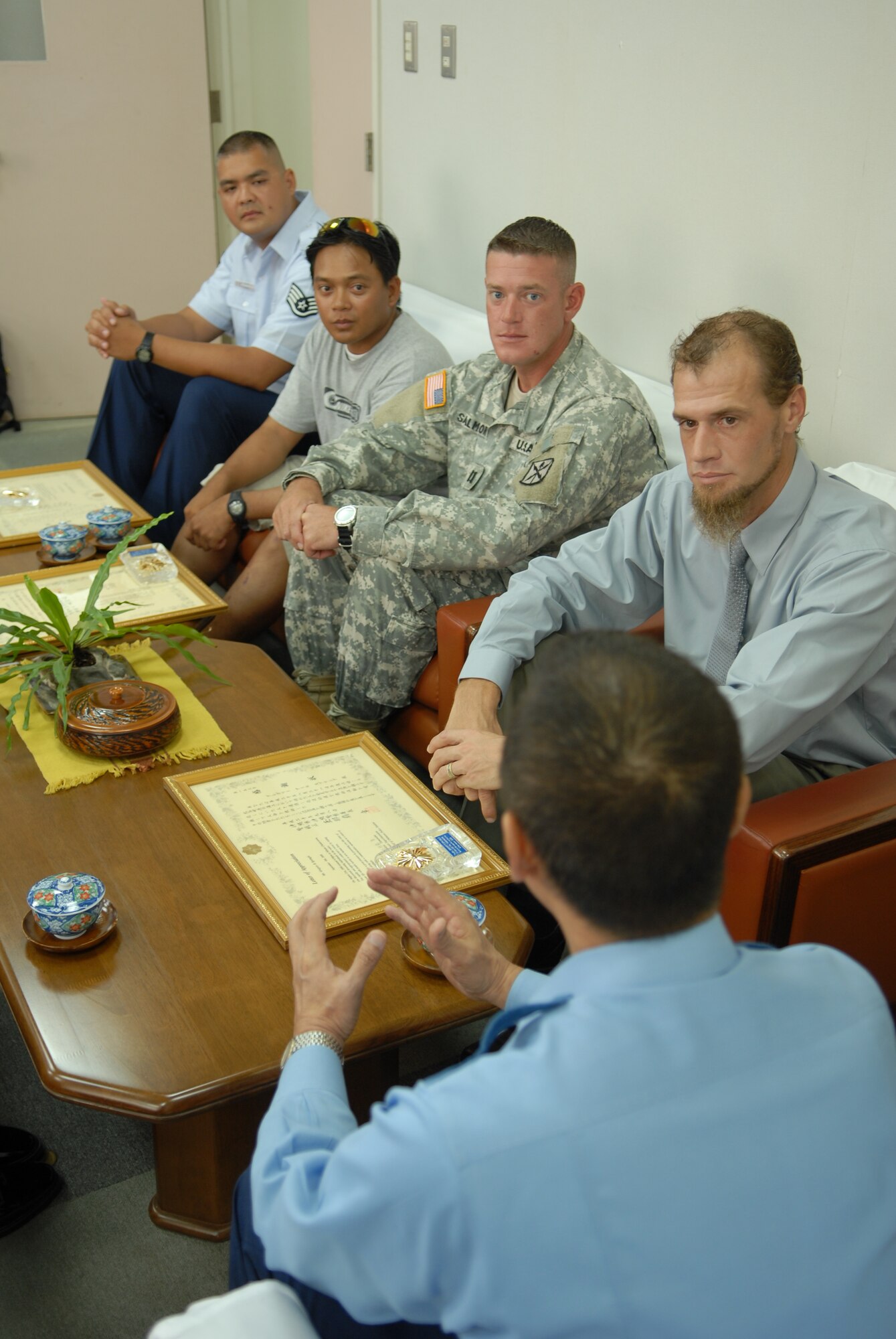 (Left to right) Staff Sgt. John Robinson, 18th Component Maintenance Squadron; Michael Sidniey, a local fisherman; Army Capt. Scott Salmon, 349th Signal Company commander, Torii Station; and Greg Springle, a scuba instructor assigned to Camp Foster, share tea and conversation with Akira Tamanaha, Okinawa Police Station chief and senior superintendent. Chief Tamanaha presented the four men with letters of appreciation for their participation in the recent rescue of an Okinawan teenager and fisherman from drowning. (U.S. Air Force photo/Staff Sgt. Nestor Cruz)