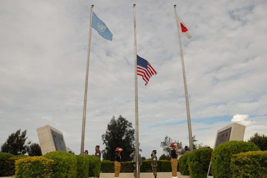 KADENA AIR BASE, Japan -- Airmen from the 18th Wing prepare to salute the flag during the 9-11 flag ceremony Sept. 11. The ceremony was held in remembrance of the victims and first responders who gave their lives in the 2001 terrorist attacks. (U.S. Air Force photo/Airman 1st Class Chad Warren)