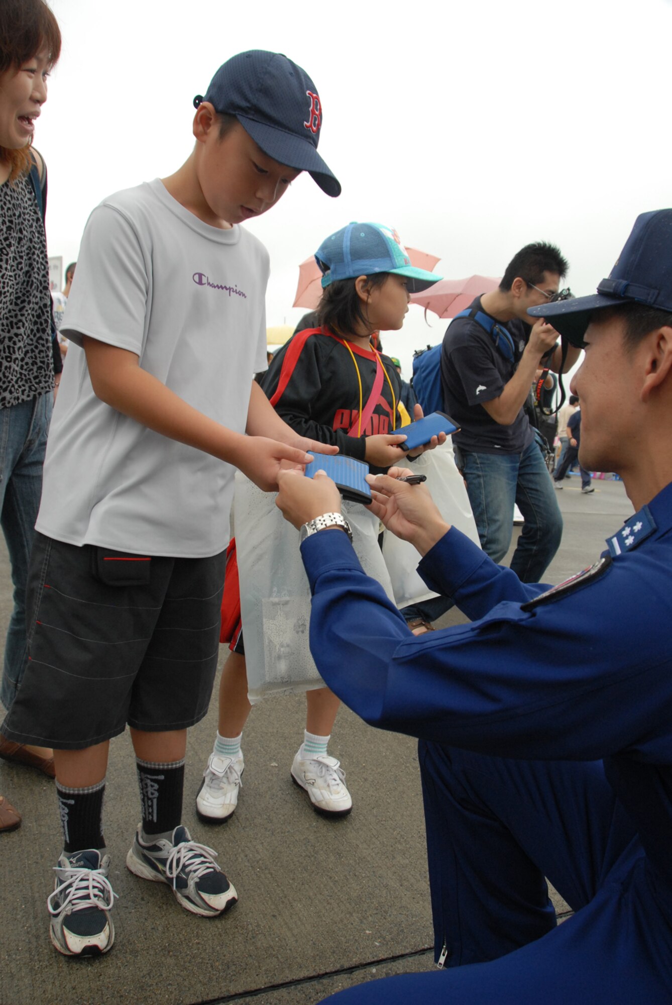 MISAWA AIR BASE, Japan -- A Japanese child receives an autograph from a member of Blue Impulse during the Misawa Air Festival Sept. 7, 2008.  Blue Impulse is the Japan Air Self-Defense Force's demonstration team. (U.S. Air Force photo by Airman 1st Class Jamal Sutter)