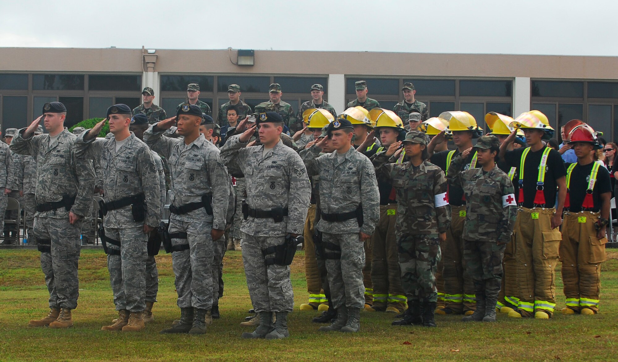 Airmen from the 18th Wing salute the flag during the 9-11 flag ceremony at Kadena Air Base, Japan, Sept. 11, 2008. The ceremony was held in remembrance of the victims and first responders who gave their lives in the 2001 terrorist attacks. (U.S. Air Force photo/Airman 1st Class Amanda Grabiec)