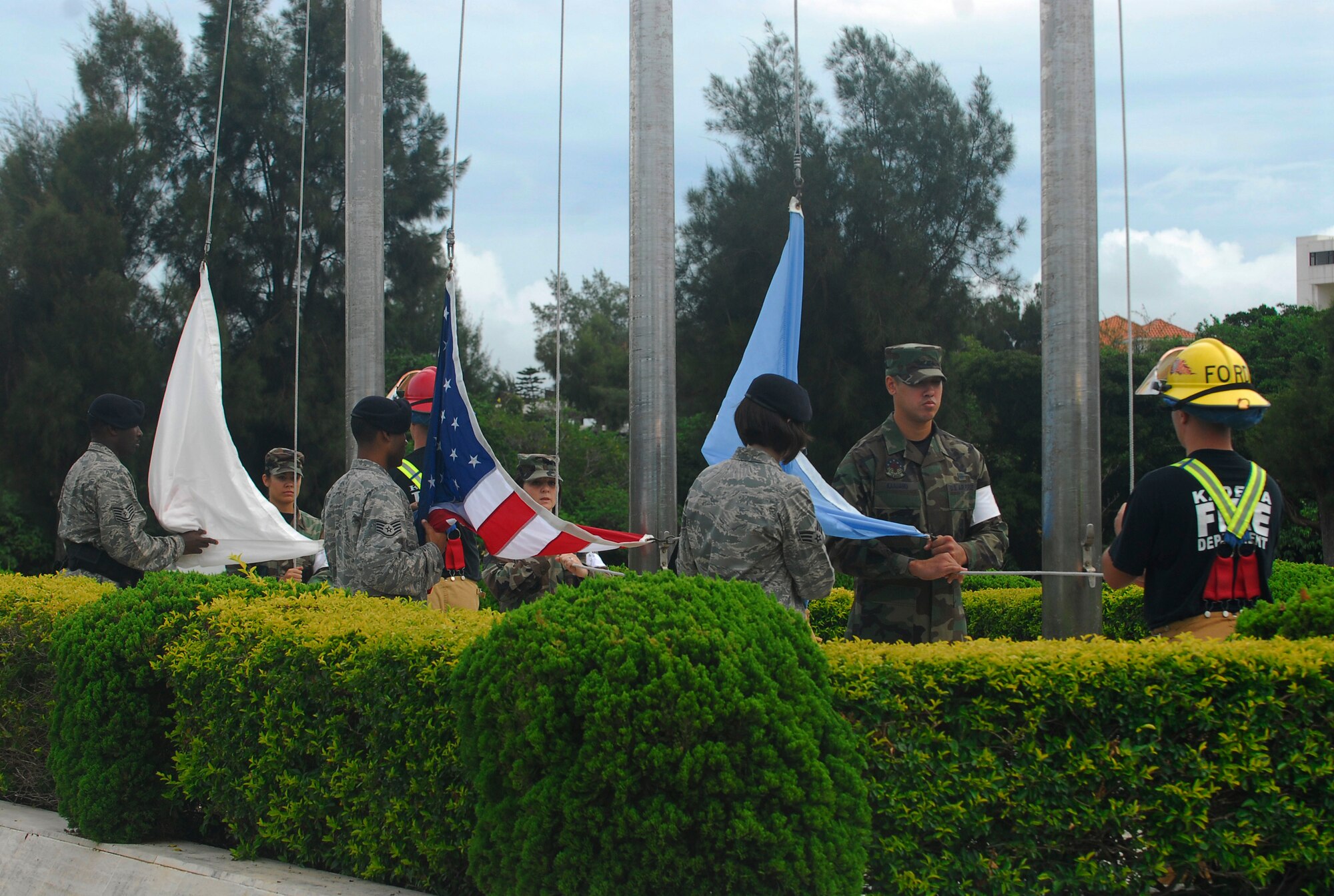Airmen from the 18th Wing prepare to raise the flag during the 9-11 flag ceremony at Kadena Air Base, Japan, Sept. 11, 2008. The ceremony was held in remembrance of the victims and first responders who gave their lives in the 2001 terrorist attacks. (U.S. Air Force photo/Airman 1st Class Amanda Grabiec)