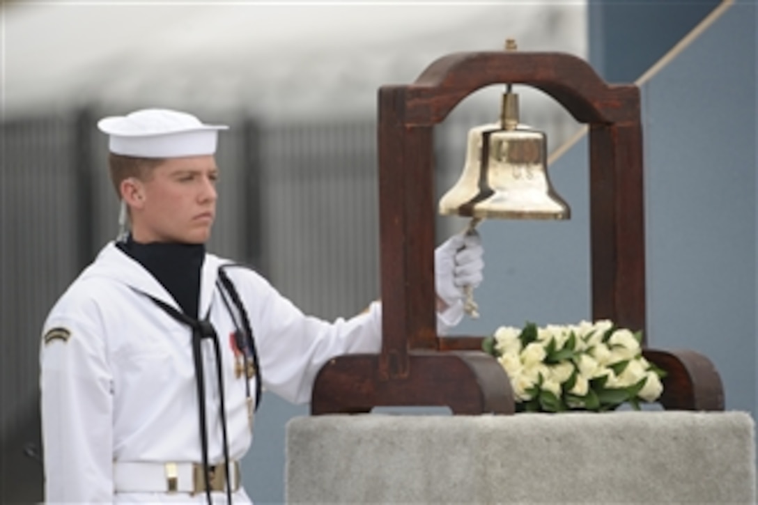 A U.S. Navy sailor rings a bell as the name of each person lost at the Pentagon is read during the Pentagon Memorial dedication ceremony on Sept. 11, 2008.  The national memorial consists of 184 inscribed memorial units honoring the 59 people aboard American Airlines Flight 77 and the 125 in the building who lost their lives Sept. 11, 2001.  