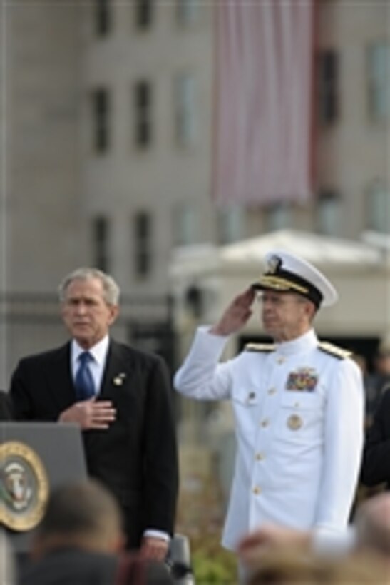 President George W. Bush and Chairman of the Joint Chiefs of Staff Adm. Mike Mullen, U.S. Navy, salute the flag during the playing of the national anthem during the Pentagon Memorial dedication ceremony on Sept. 11, 2008.  The national memorial is the first to be dedicated to those killed at the Pentagon on Sept. 11, 2001.  The site contains 184 inscribed memorial units honoring the 59 people aboard American Airlines Flight 77 and the 125 in the building who lost their lives that day.  