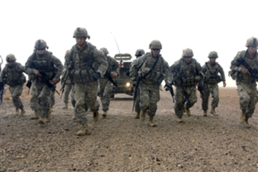 U.S. Army soldiers take off for a three-mile combat run during the Warrior Competition on Contingency Operating Base Speicher, in Tikrit, Iraq, Sept. 9, 2008. Fifty-four soldiers assigned to Multinational Division North will compete in tests of their physical strength, basic combat skills, and knowledge. 