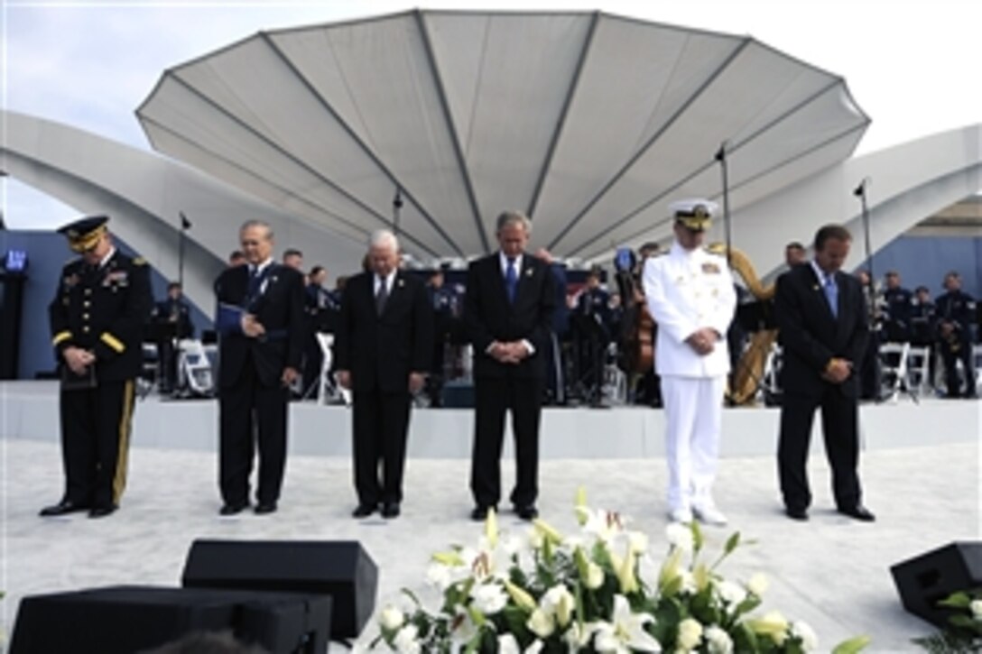 The official party holds a moment of silence during the Pentagon Memorial dedication ceremony Sept. 11, 2008. The national memorial is the first to be dedicated to those killed at the Pentagon on Sept. 11, 2001. The site contains 184 inscribed memorial units honoring the 59 people aboard American Airlines Flight 77 and the 125 in the building who lost their lives that day.