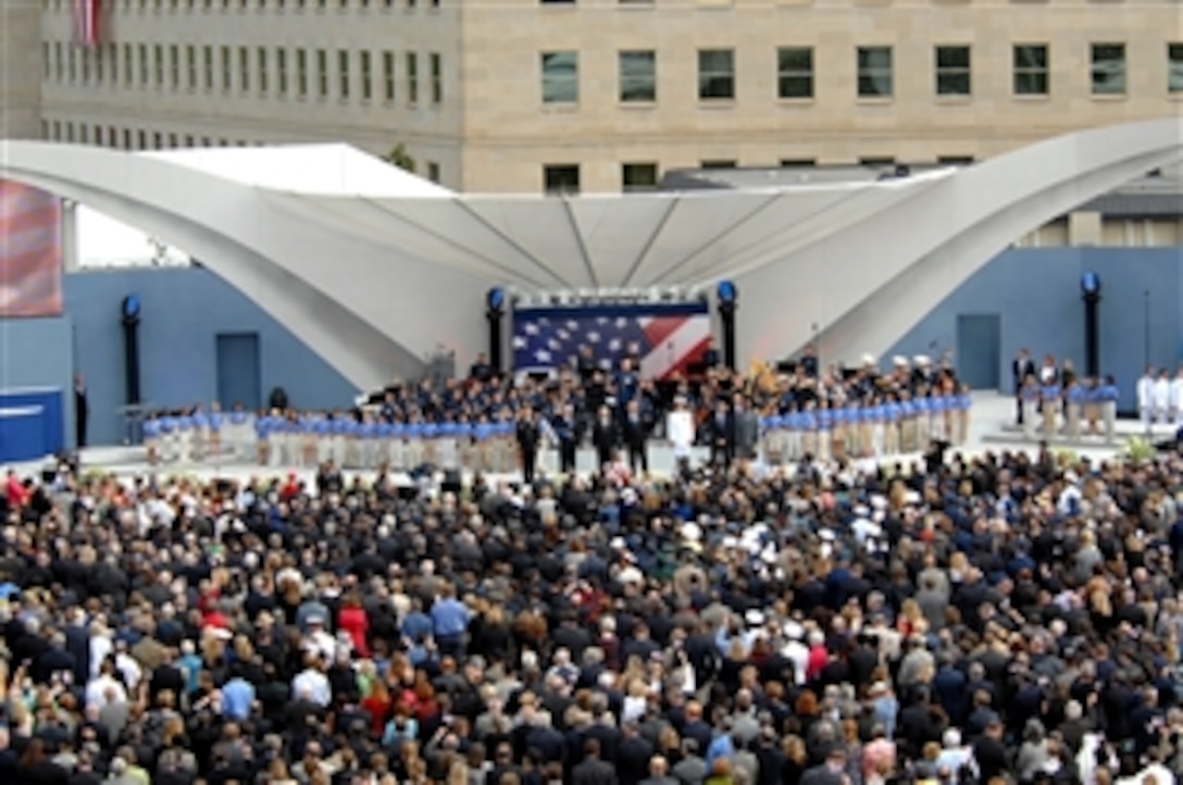 The official party and audience sing "God Bless America" at the Pentagon Memorial Dedication Ceremony, Sept. 11, 2008. The national memorial is the first to be dedicated to those killed at the Pentagon on Sept. 11, 2001. The site contains 184 inscribed memorial units honoring the 59 people aboard American Airlines Flight 77 and the 125 in the building who lost their lives that day.