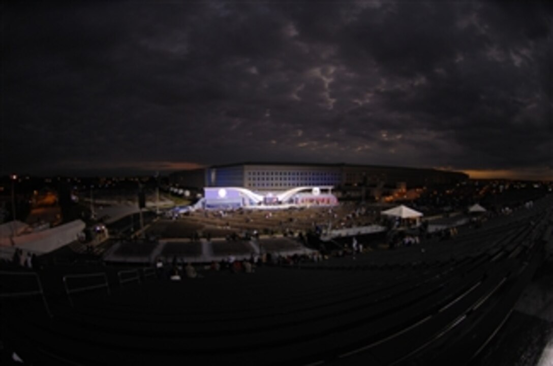 The sun rises over the main stage before the start of the Pentagon Memorial dedication ceremony on Sept. 11, 2008.  The national memorial is the first to be dedicated to those killed at the Pentagon on Sept. 11, 2001.  The site contains 184 inscribed memorial units honoring the 59 people aboard American Airlines Flight 77 and the 125 in the building who lost their lives that day.  