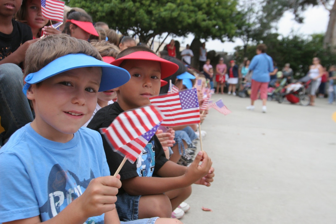 Josh Bean, 5 and Mike Allen Hernandez, 6, wave their American flags to commemorate the seven-year anniversary of Sept. 11, 2001 during Mary Fay Pendleton Elementary school's 2nd Annual Freedom Walk, Sept. 11. The event began with a base-wide moment of silence, presentation of the nation's colors and several guest speakers.