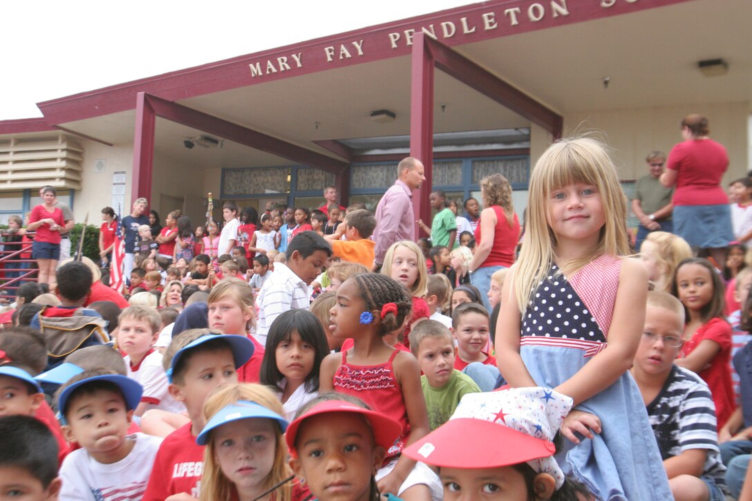 Amber Ann Russell, 5, stands up among the crowd of students to show her enthusiasim during the opening events of the 2nd Annual Mary Fay Pendleton Elementary school freedom walk, Sept. 11. Approximately 778 students participated in the event.