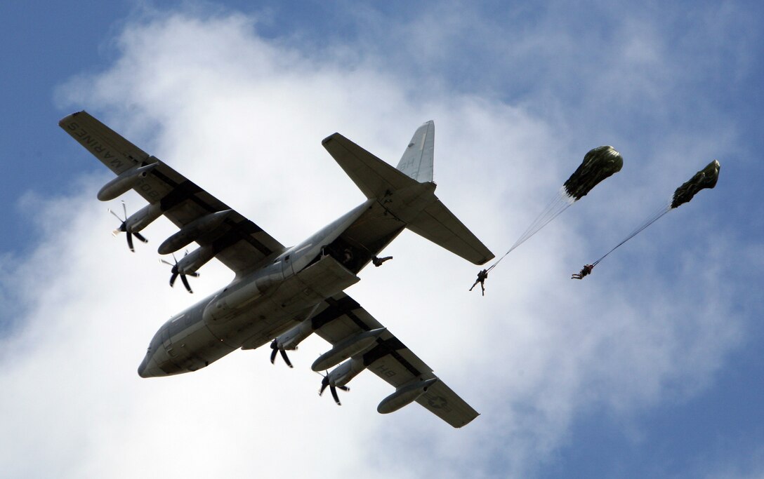 The Marines with 2nd Reconnaissance Battalion, 2nd Marine Division, practice low static-line parachute jumps from a C-130 Hercules airplane above Camp Davis, N.C., Sept. 11. As the Marines exited the rear of the airplane, leaping into the wind, they locked themselves into a bent-over position they had rehearsed many times.