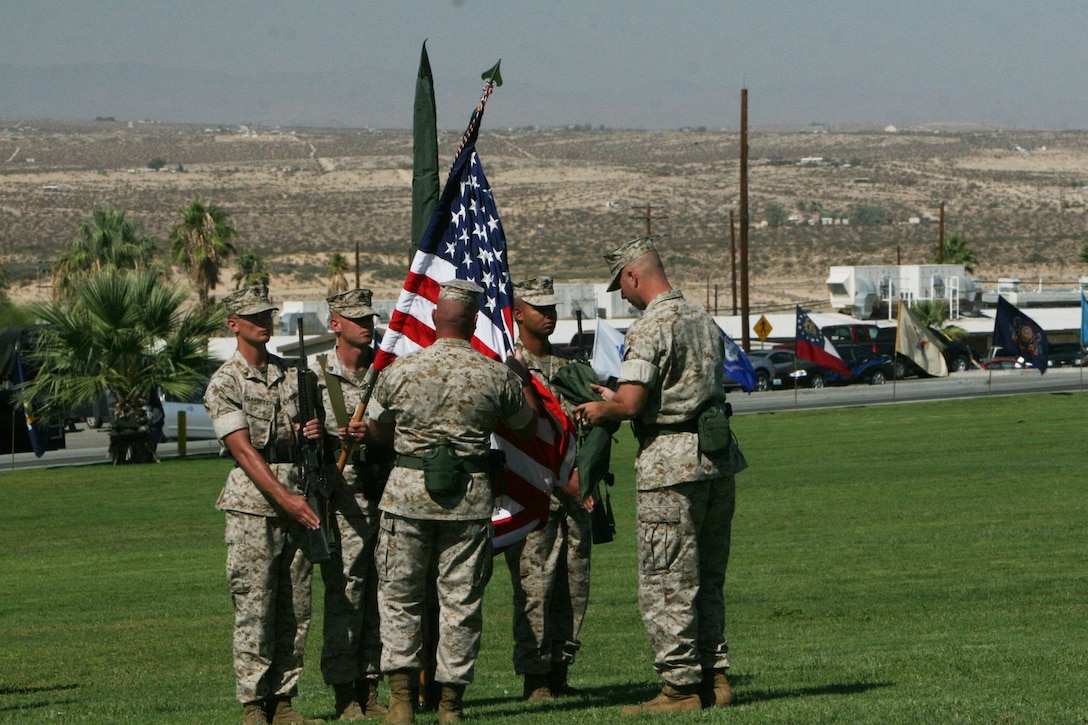 Sgt. Maj. Rufino Mendez  Jr. and Lt. Col. James W. Frey uncase the colors of the American flag, and Marine Unmanned Aerial Vehicle Squadron 3's unit colors.  VMU-3 was activated during a ceremony at the Combat Center’s Lance Cpl. Torrey L. Gray Field Sept. 12.