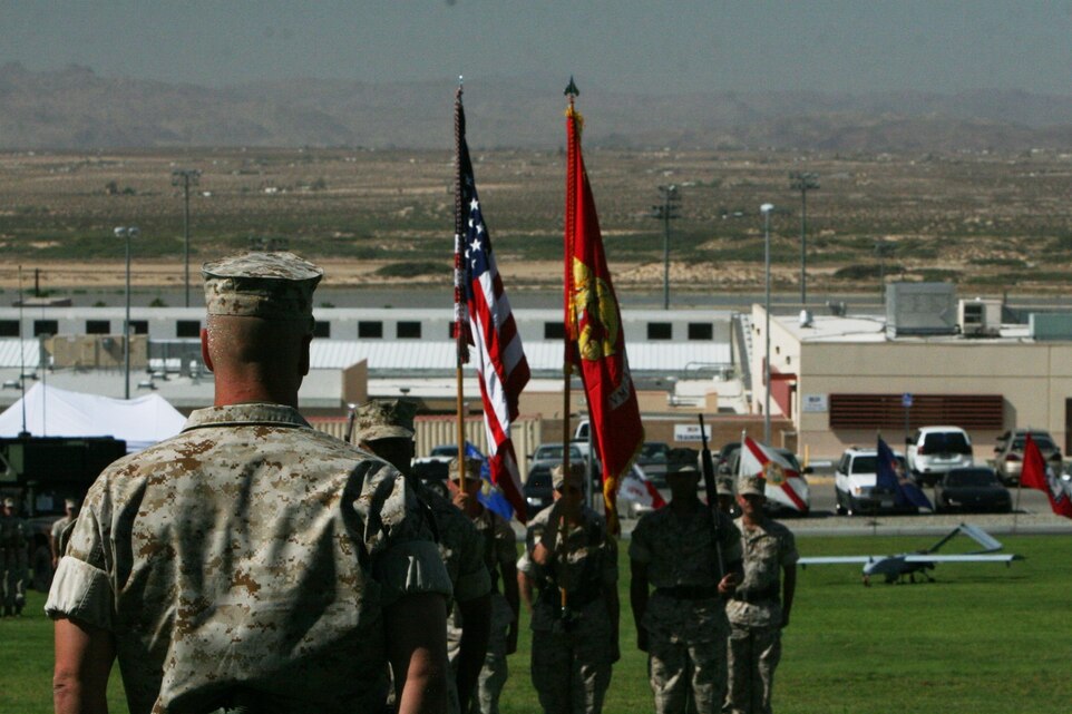 Maj. James Scott presents the unit colors and national ensign to Lt. Col. James W. Frey, the commanding officer of Marine Unmanned Aerial Vehicle Squadron 3.  VMU-3 was activated during a ceremony at the Combat Center’s Lance Cpl. Torrey L. Gray Field Sept. 12.