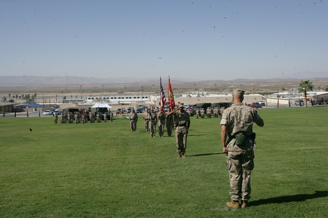 Maj. James Scott presents the unit colors and national ensign to Lt. Col. James W. Frey, the commanding officer of VMU-3.  VMU-3 was activated during a ceremony at the Combat Center’s Lance Cpl. Torrey L. Gray Field Sept. 12.