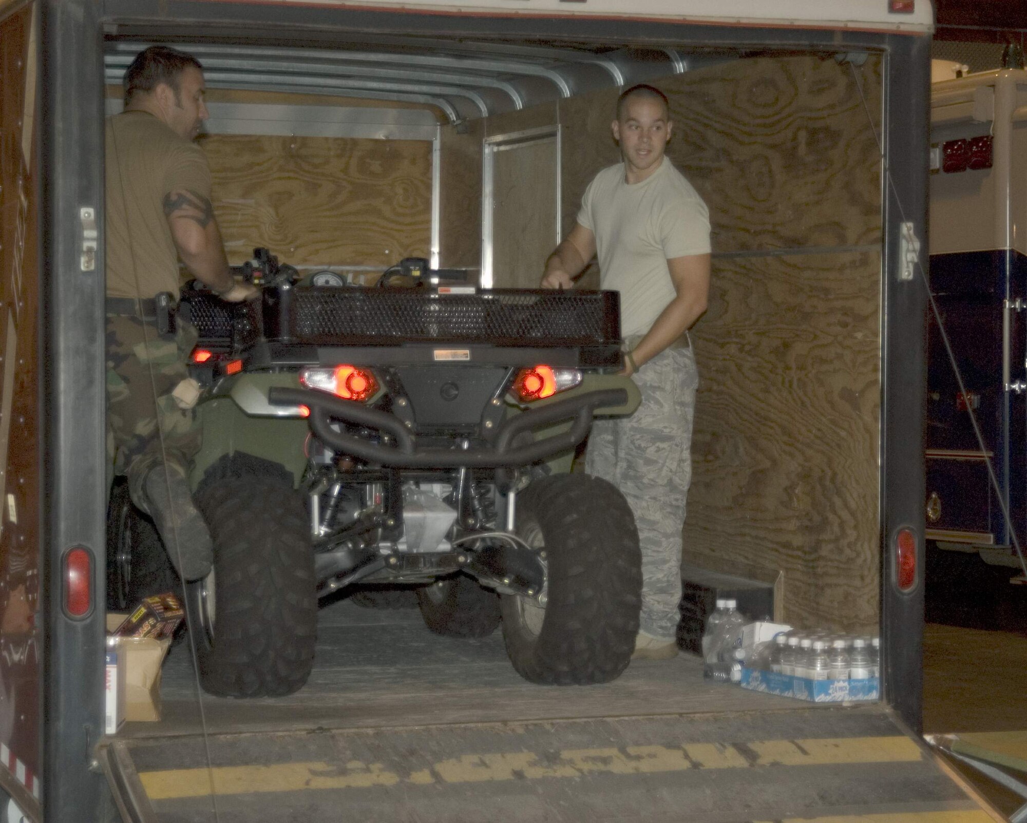 Staff Sgt. James McGregor and Tech. Sgt. Zach Shaffer uncrate an all-terrain vehicle Sept. 12 at the Reliant Center in Houston. The Oregon Air National Guard's 125th Special Tactics Squadron is in Houston to assist with Hurricane Ike relief efforts. Sergeant McGregor is a parachute rigger, and Sergeant Shaffer is a radio maintainer, and both from the 125th STS. (U.S. Air Force photo/Tech. Sgt. Stacy Simon)
