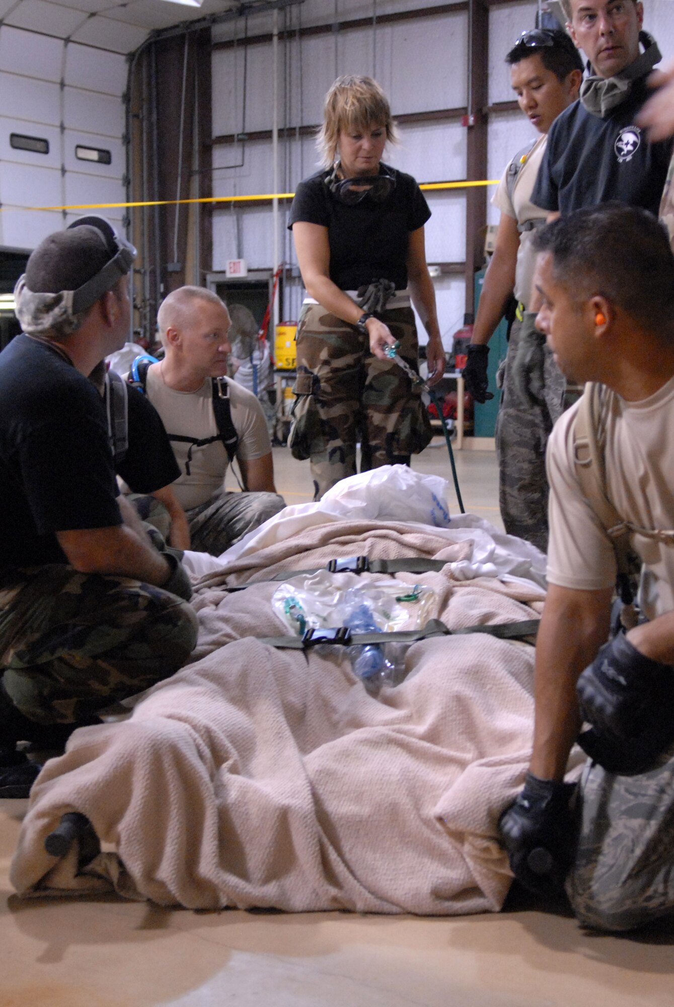 BEAUMONT AIRPORT, Texas -- U.S. Air Force Airmen made up of active duty, Guard, and Reserve from multiple Air Force Bases load hospital patients onto a C-130 aircraft, September 12, 2008. Little Rock Air Force Base C-130s were deployed to perform aero medical and transportation missions in preparation for Hurricane Ike's landfall in southern Texas.  (U.S. Air Force photo by Staff Sgt. Chris Willis) (RELEASED)