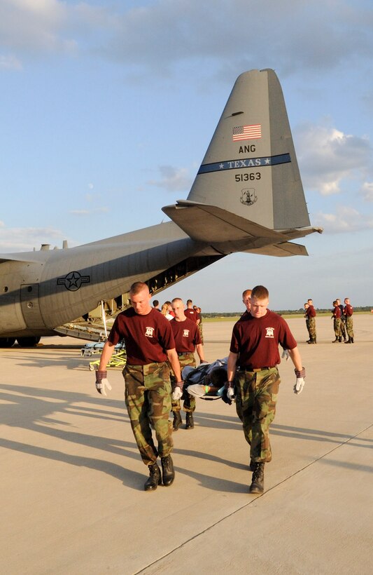 Corp of Cadets and other students from Texas A&M University, Bryan-College Station deplane special needs patients from Beaumont, Tx on board the C-130H belonging to the 136th Airlift Wing, Texas Air National Guard. College Station is the holding area for the displaced patients awaiting the outcome of Hurricane Ike. The Corp of Cadets assisted in over 200 patient evacuations all through the day and night on Sept 11, 2008. (Air Force Photo by: SMSgt Elizabeth Gilbert)