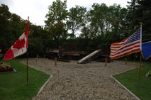 MINOT AIR FORCE BASE, N.D. - The American and Canadian flags stand tall in front of the 9/11 Memorial at the International Peace Garden in Dunseith, N.D., which borders Canada and the United States. The memorial is made of pieces of the World Trade Center. Approximately 400 individuals from Minot AFB, surrounding North Dakota communities, and Canada gathered in front ofthe memorial for a service to honor the thousands of men and women who were tragically killed in the terrorist attacks of Sept. 11, 2001. (U.S. Air Force photo by Senior Airman Cassandra Jones)