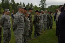 MINOT AIR FORCE BASE, N.D. - The American and Canadian flags stand tall in front of the 9/11 Memorial at the International Peace Garden in Dunseith, N.D., which borders Canada and the United States. The memorial is made of pieces of the World Trade Center. Approximately 400 individuals from Minot AFB, surrounding North Dakota communities, and Canada gathered in front ofthe memorial for a service to honor the thousands of men and women who were tragically killed in the terrorist attacks of Sept. 11, 2001. (U.S. Air Force photo by Senior Airman Cassandra Jones)