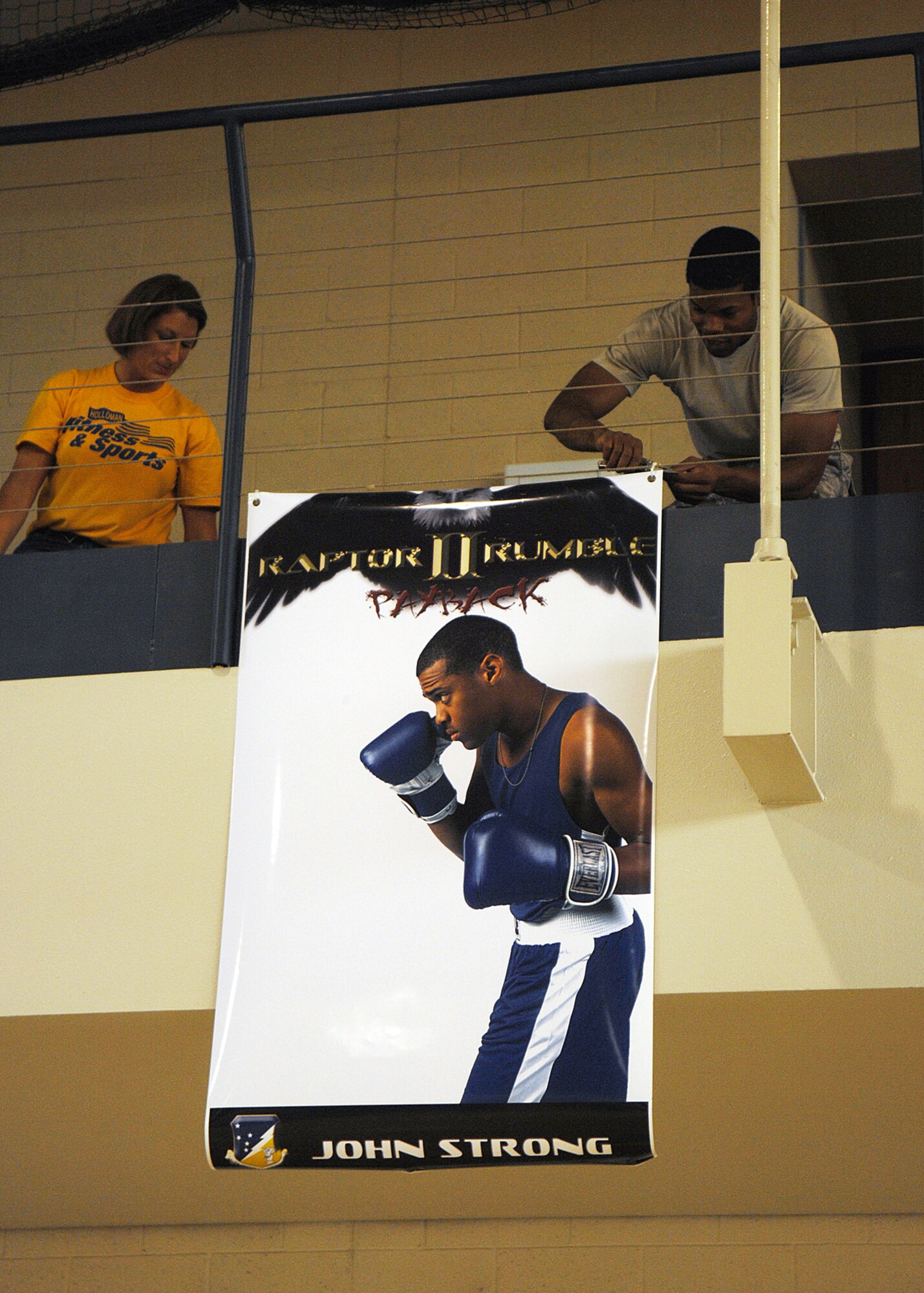 Volunteers from Team Holloman, help set up the gym for "Raptor Rumble 2," Sept 12. Volunteers hang photos of the fighters from the gym in preparation for tonight's fights. Raptor Rumble is an annual boxing event held at Holloman for Air Force Service members to participate in amateur boxing. The Raptor Rumble event will be held at the Fitness Center.

(U.S. Air Force photo/ Senior Airman Anthony Nelson)
