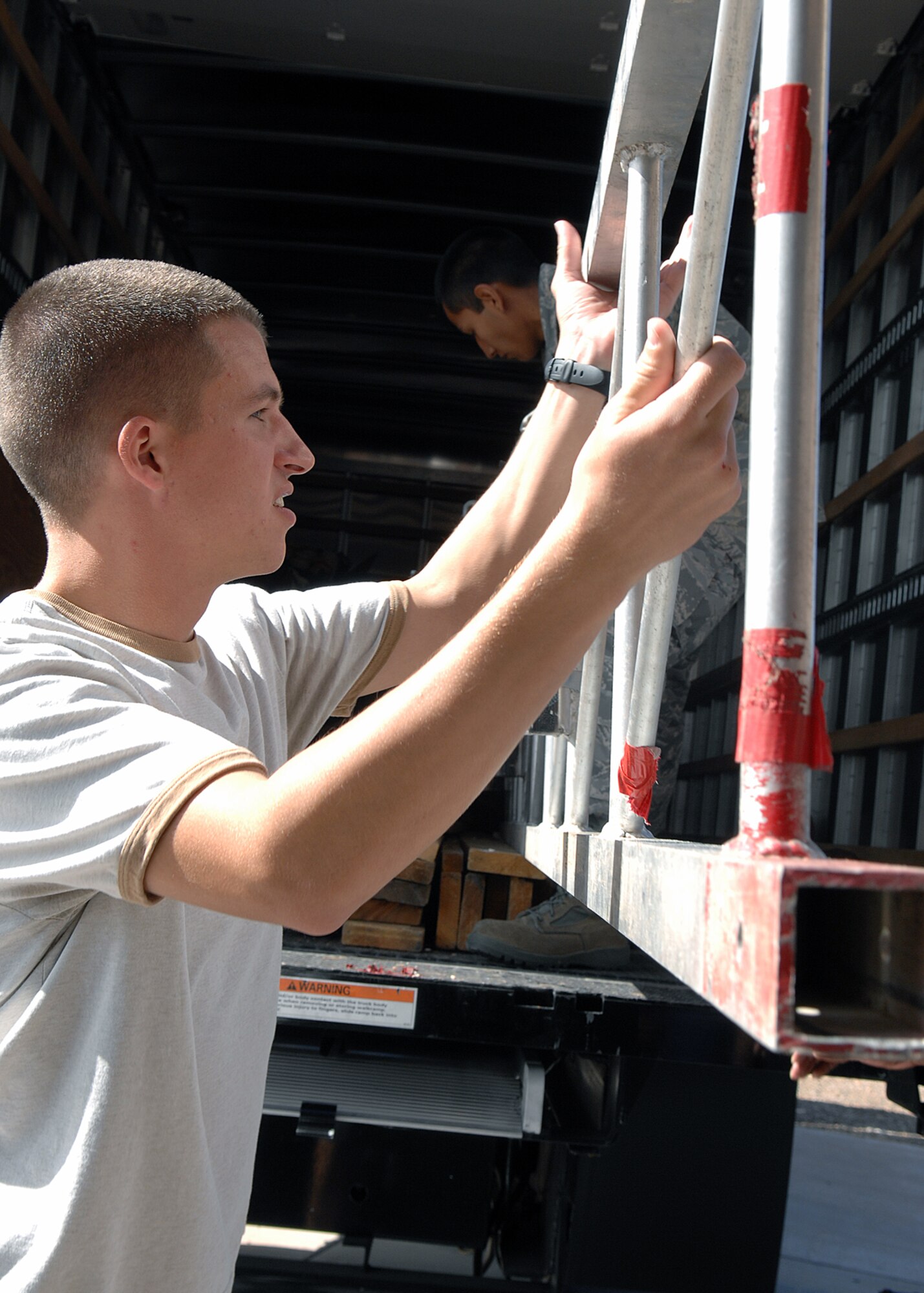 Airman 1st Class William Schull, 49th Communications Squadron, helps unload and set up the boxing ring for "Raptor Rumble 2," Sept 12. Raptor Rumble is an annual boxing event held at Holloman for Air Force Service members to participate in amateur boxing. 

(U.S. Air Force photo/ Senior Airman Anthony Nelson)
