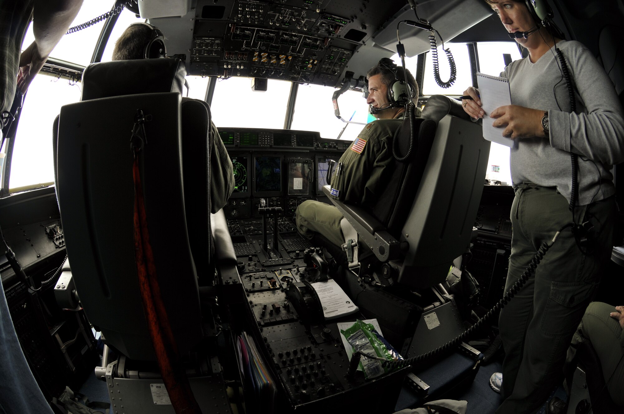 While flying into Hurricane Ike, Maj. Jeff Ragusa, pilot, 53rd Weather Reconnaissance Squadron, answers questions posed by Amy Schlesing of the Arkansas Democrat-Gazette. (U.S. Air Force Photo/Tech. Sgt. James B. Pritchett)