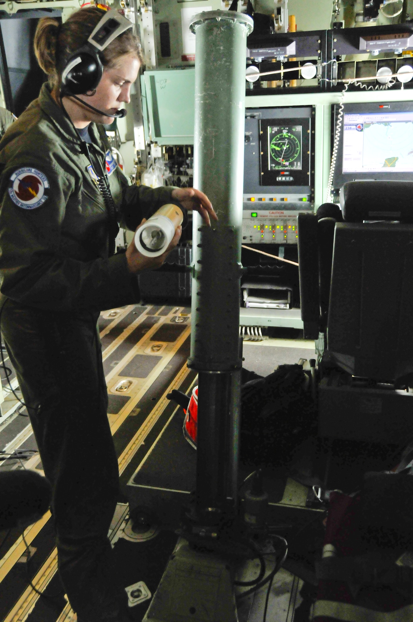 Staff Sgt. Shannon Smith prepares to launch a dropsonde from a WC-130J aircraft. Flown by the 53rd Weather Reocnnaissance Squadron, known as the Hurricane Hunters, the WC-130J has two removable pallets onboard for the weather mission. Weather Reconnaissance Loadmasters, such as Sergeant Smith, launch dropsondes throughout the average 10-12 hour flight, gathering data the Reservists provide to the National Hurricane Center. (U.S. Air Force Photo/Tech. Sgt. James B. Pritchett)