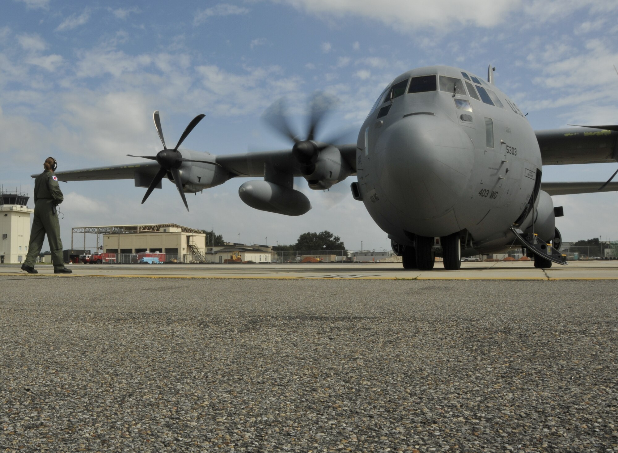 As the first engine on a WC-130J spins up, Staff Sgt. Shannon Smith, weather reconnaissance loadmaster, communicates with the pilots on board. Sergeant Smith and the Hurricane Hunters flew into Hurricane Ike yesterday as the massive storm approached the Texas coast. (U.S. Air Force Photo/Tech. Sgt. James B. Pritchett)
